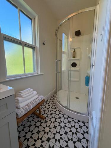 a bathroom with a shower with black and white tiles at Little Banook B&B in Halifax