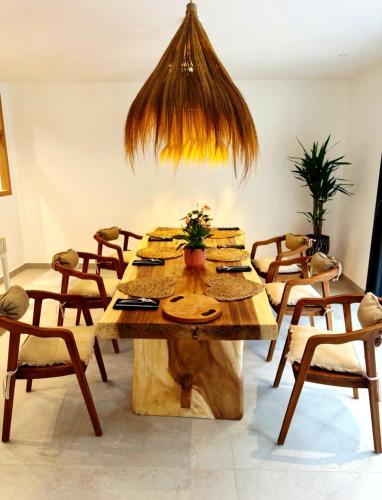 a large wooden table in a room with chairs at Maison Mahana in Bonifacio