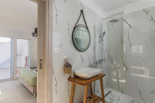 a bathroom with a sink and a shower at Azura creta in Gra Liyiá