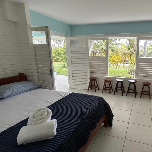 a bedroom with a bed with two towels on it at Casa Jauá ParaisodePainho in Camaçari