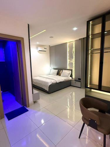 a bedroom with a bed and a chair in it at Cosmos in Lagos