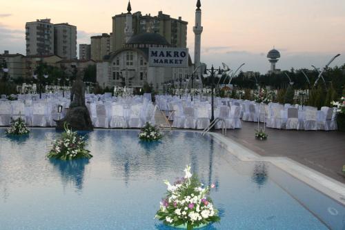 a wedding set up in the water with white chairs at Buyukhanli Park Hotel in Ankara