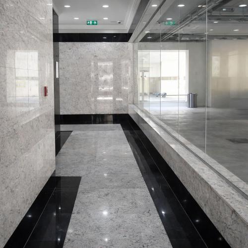 a hallway of a building with glass walls at Burdubai Vacation Homes in Dubai