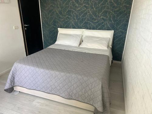 a bed with two pillows on it in a room at Camera con Bagno ingresso autonomo in Taranto
