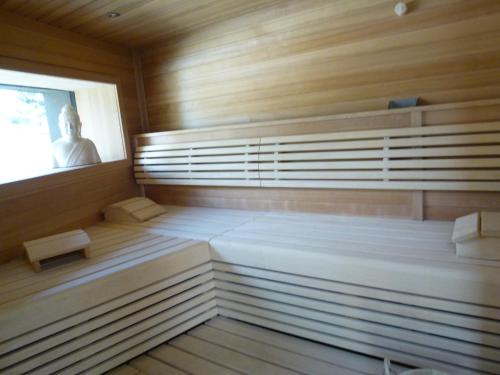a sauna with a man sitting in the window at Hotel Landhaus Moserhof in Gumpoldskirchen