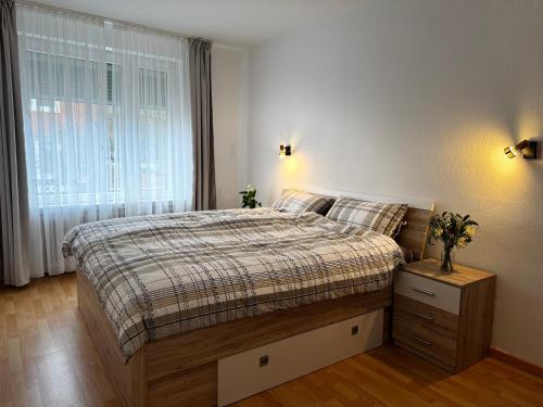 a bedroom with a large bed and a window at Vina Ferienwohnung in Emden