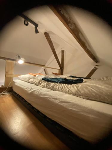 a bed in a room with a ceiling at La charmante petite maison in Croix