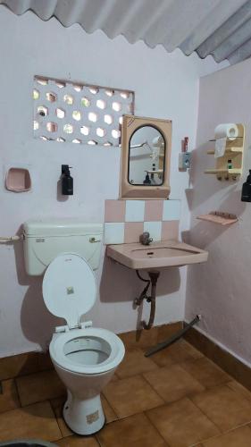 a bathroom with a toilet and a sink at Le Stories Heritage Home in Kottayam