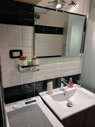 a bathroom with a sink and a mirror at L'antica torre in Tuscania