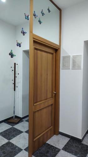 a wooden door in a room with butterflies on the wall at Silvia Butterfly Flat in Genoa