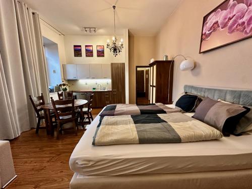 a bedroom with a bed and a dining room at Home Away main square apartment - sleeps 6 - AC - Balcony - Coffee Machine - Washer - Kitchen - Parking in Poprad