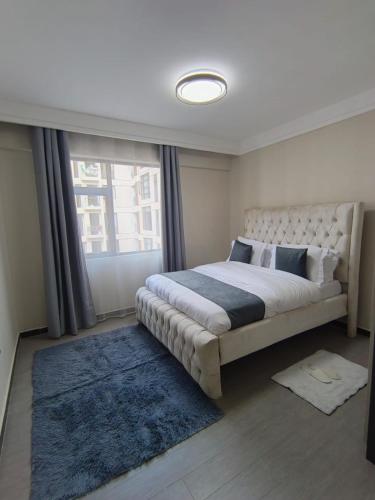 a bedroom with a large bed and a window at joy in Nairobi