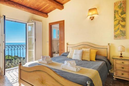 a bedroom with a bed with a view of the ocean at Agriturismo Le Pale in Bogliasco