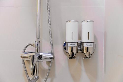 a bathroom with two lights on the wall at Sunrise Stay in Male City