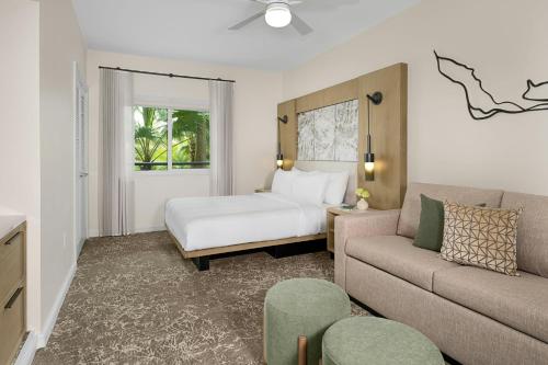 a hotel room with a bed and a couch at Marriott's Imperial Palms Villas in Orlando