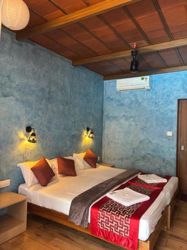 a bedroom with a large bed in a room at Ponyo Stays in Cochin