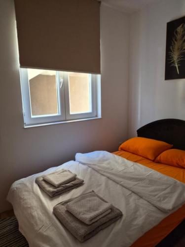 a bed with towels on it in a room at Stan Duo in Herceg-Novi