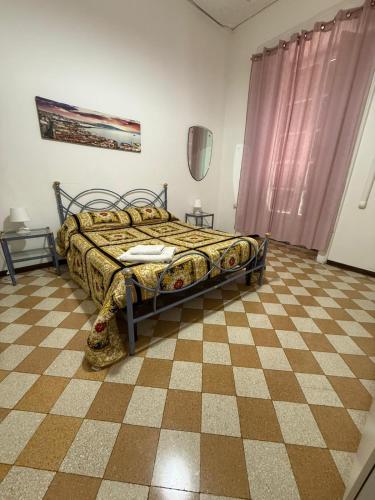 a bedroom with a bed and a checkered floor at Da Alfred in Naples