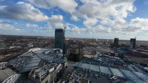 an aerial view of a city with a tall building at Nirbhao in Birmingham