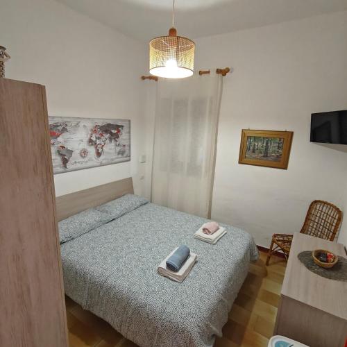 a bedroom with a bed with a book on it at Cottage84Milazzo in Milazzo