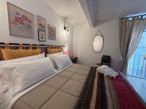 a bedroom with a large bed and a window at postAielli - Arte, Natura e Relax in Aielli