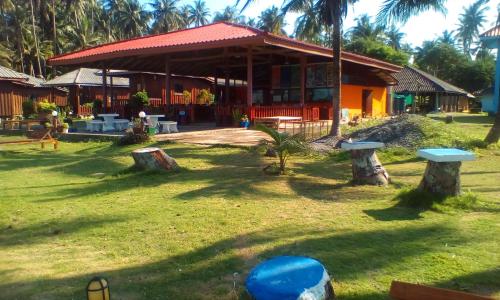 a house with a yard with trees in front of it at Happy Days Resort in Ko Mak