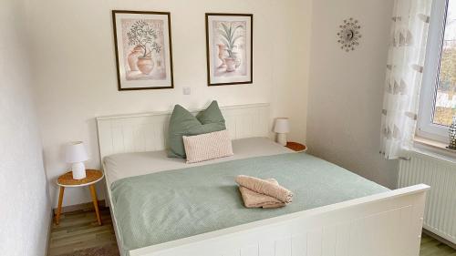 a bedroom with a bed with two pillows on it at Ferienwohnung Schmid Lautrach im Illerwinkel in Lautrach