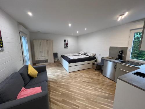 a living room with a couch and a kitchen at Königshof Studio in Monschau