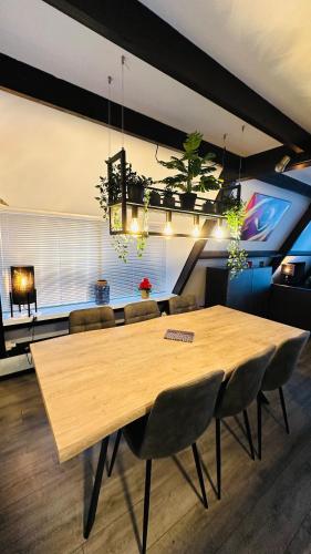 a dining room with a wooden table and chairs at Villa Edice met zwembad en restaurant in Durbuy - honden toegelaten in Durbuy
