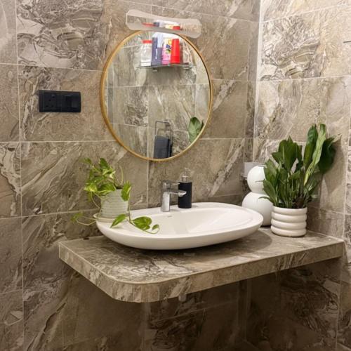 a bathroom with a sink and a mirror at Nuwan Home Vacation Villa in Wennappuwa