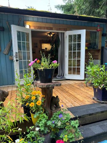 a patio with a bunch of flowers and plants at Sea 'N' Stars BNB in Gabriola