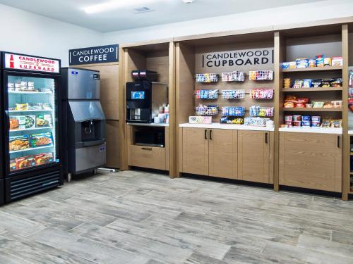 a store with a refrigerator and shelves with food at Suburban Studios Avondale in Avondale