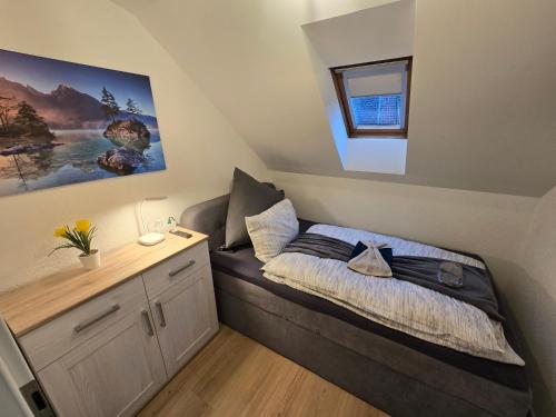 a small bedroom with a bed with a desk at Apartment an der Prims Nalbach in Nalbach