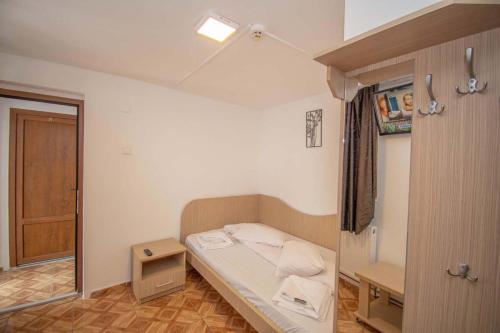 a small room with a bed in a room at La David Straja in Straja