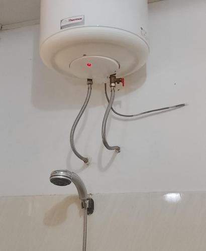 a white light on the ceiling of a bathroom at Avocado Lodge in Lushoto