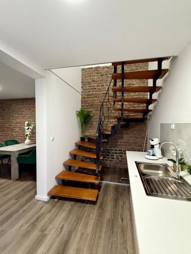 a kitchen with a staircase in a house at Apartment Mira 13 in Pulheim