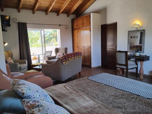 a living room with a couch and chairs and a table at Quinta do Paraiso in São Teotónio