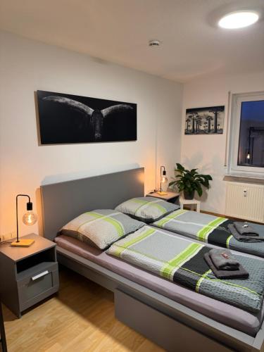 a bedroom with a bed and a tv on the wall at Lakeview Apartment in Schluchsee