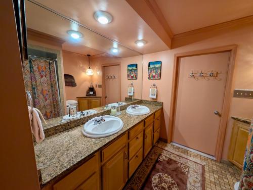 a bathroom with two sinks and a large mirror at Creekside Paradise in Tybee Island