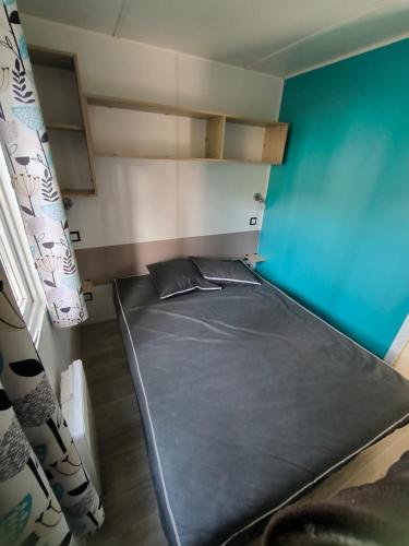 a small room with a bed in a room at Camping les Olyats in Seignosse