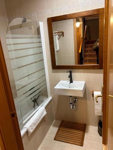 a bathroom with a sink and a mirror at Chalet Hoz de Jaca in Hoz de Jaca