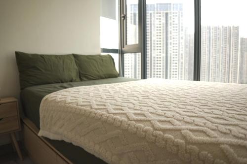 a bedroom with a bed and a large window at Minimalist Living , One bedroom in Phnom Penh