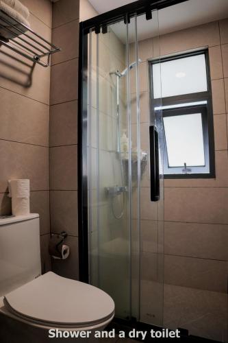 a shower and a dry toilet in a bathroom at Minimalist Living , One bedroom in Phnom Penh