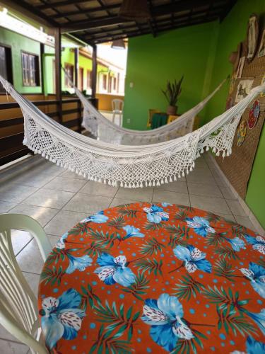 a hammock in a room with a table and chairs at Pousada Recanto Lagoa Azul in Baixio