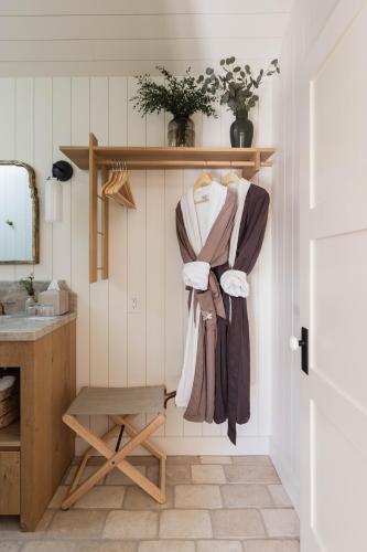 a room with a sink and a shelf with clothes at Orchard Hill in Julian