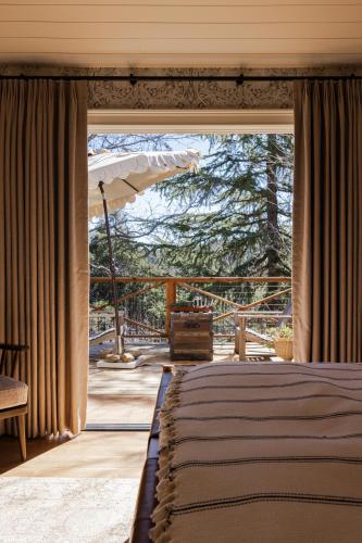 a bedroom with a bed and a large window at Orchard Hill in Julian