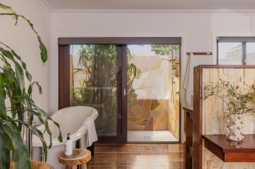 a living room with a sliding glass door at Away Guesthouse- Away on Shirley Lane in Byron Bay