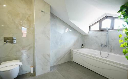 a bathroom with a toilet and a bath tub at Villa Karya in Dalyan