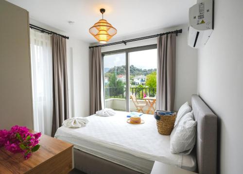 a room with a bed and a window and a table at Villa Karya in Dalyan