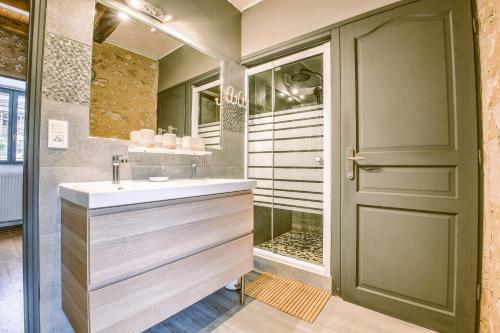 a bathroom with a sink and a shower at La Colline Truffière in Sourzac